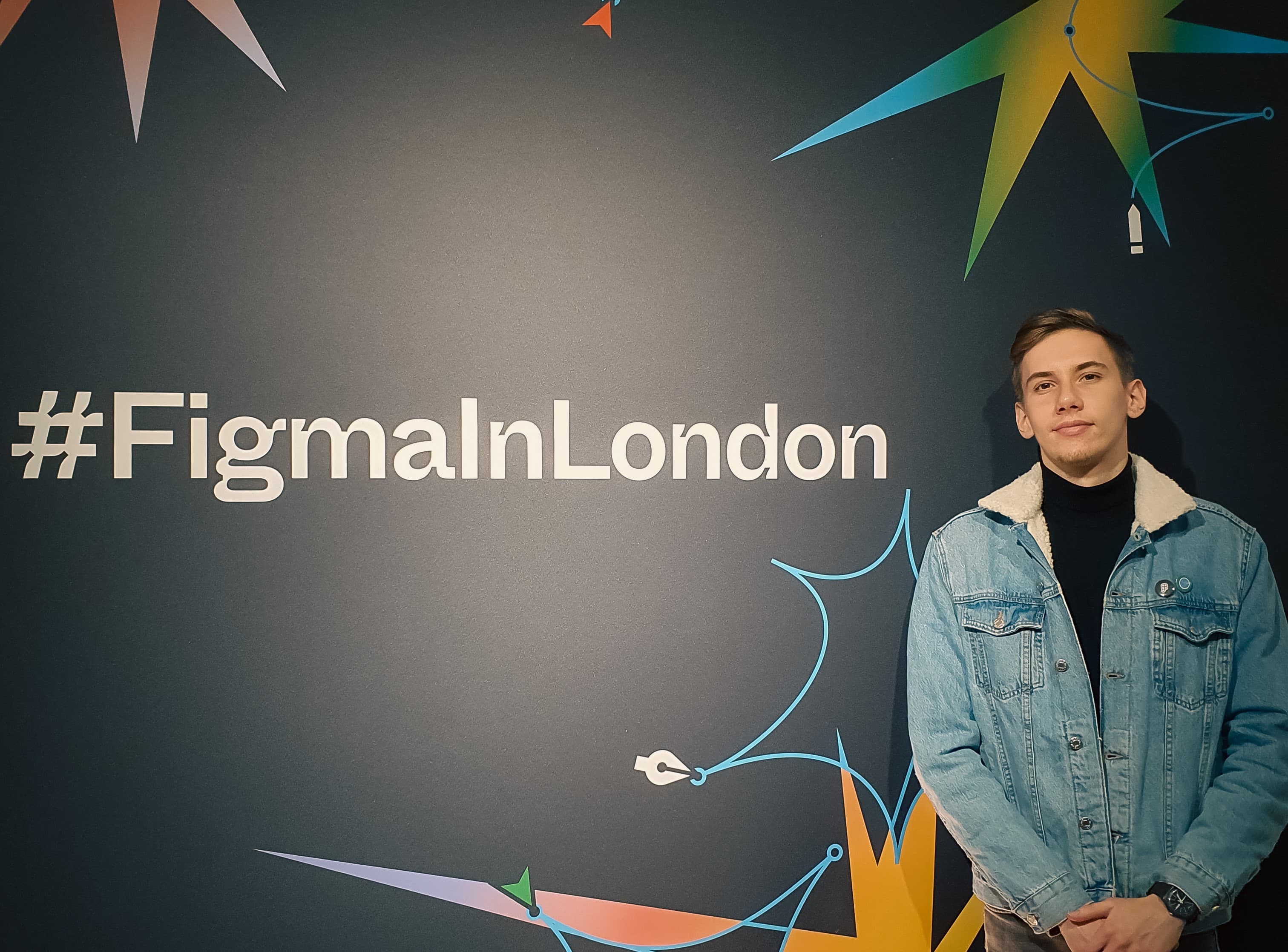 Jakub Staniszewski standing next to #FigmaInLondon 2022 banner